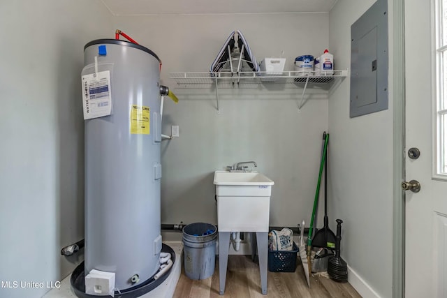 utility room featuring electric water heater and electric panel