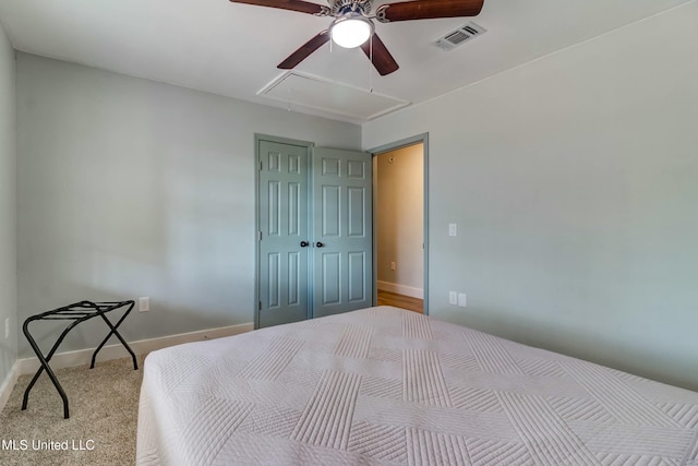 bedroom featuring light carpet, ceiling fan, and a closet