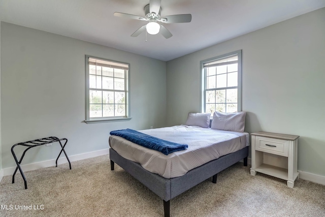 carpeted bedroom featuring ceiling fan and multiple windows