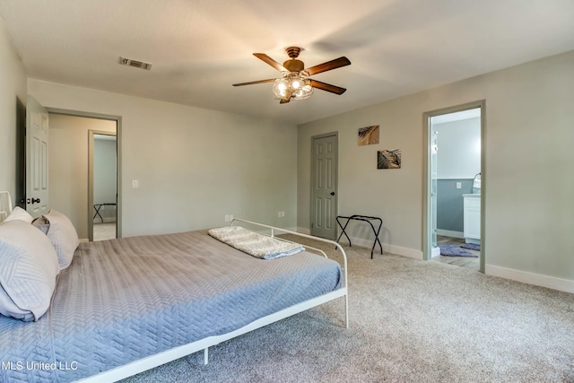 carpeted bedroom featuring ceiling fan and ensuite bathroom