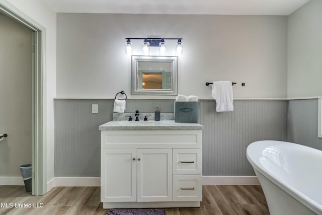 bathroom featuring vanity, a bathtub, and hardwood / wood-style floors