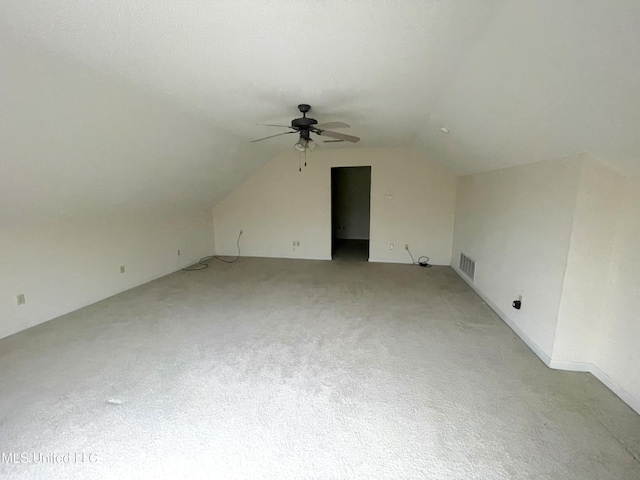 bonus room with a ceiling fan, visible vents, light carpet, and lofted ceiling