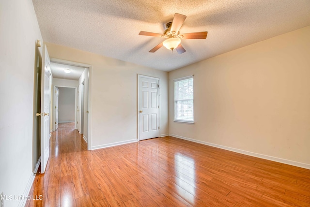 7643 Broken Hickory Dr, Walls, MS 38680 - unfurnished bedroom with a textured ceiling, light wood finished floors, baseboards, and a ceiling fan