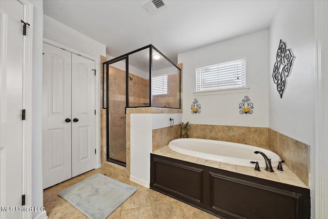 bathroom with a garden tub and a stall shower