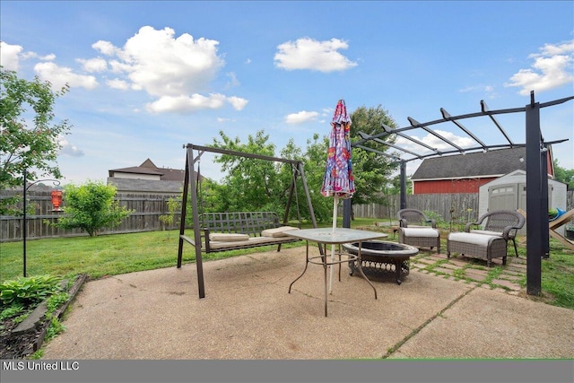 view of patio with a storage shed, an outdoor structure, and a fire pit