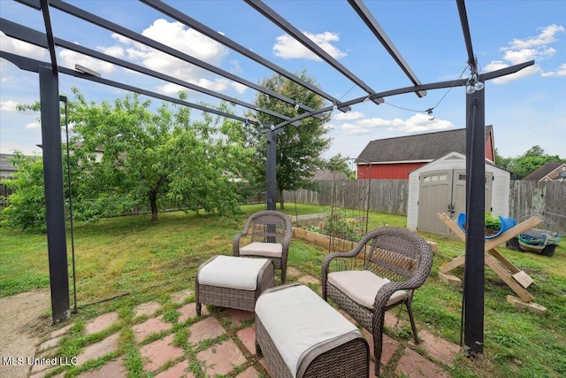view of yard featuring a storage unit, a pergola, an outbuilding, and a patio