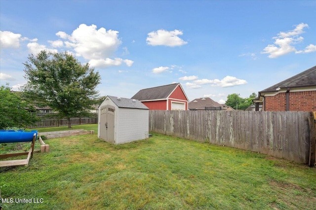 view of yard featuring a storage shed and an outdoor structure