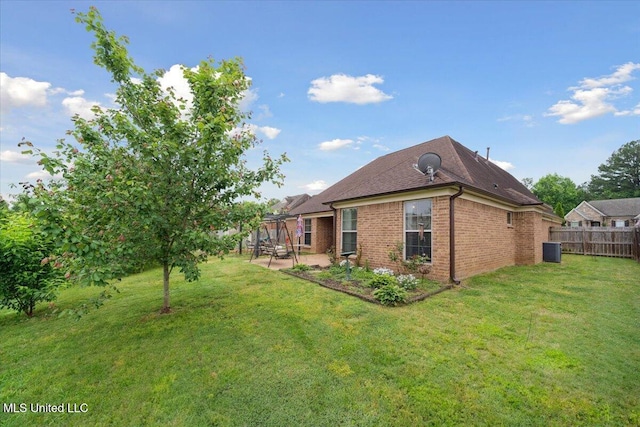 view of side of property with a patio area, brick siding, and central air condition unit