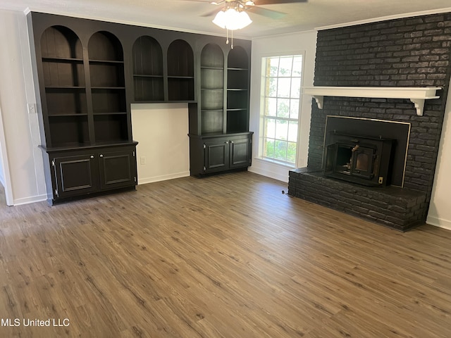 unfurnished living room featuring hardwood / wood-style flooring, ceiling fan, and ornamental molding