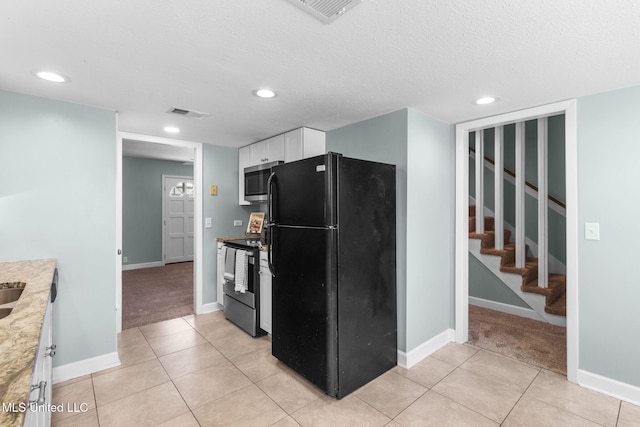 kitchen featuring white cabinets, light tile patterned flooring, appliances with stainless steel finishes, recessed lighting, and visible vents