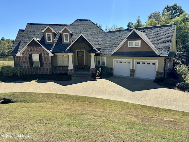 4 Mallard Xing, Raymond, MS 39154 - craftsman house featuring brick siding, a front yard, driveway, and an attached garage