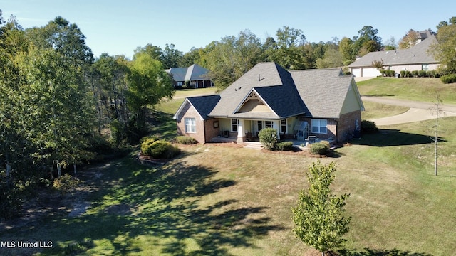 4 Mallard Xing, Raymond, MS 39154 - view of front of house with covered porch, a front yard, brick siding, and roof with shingles