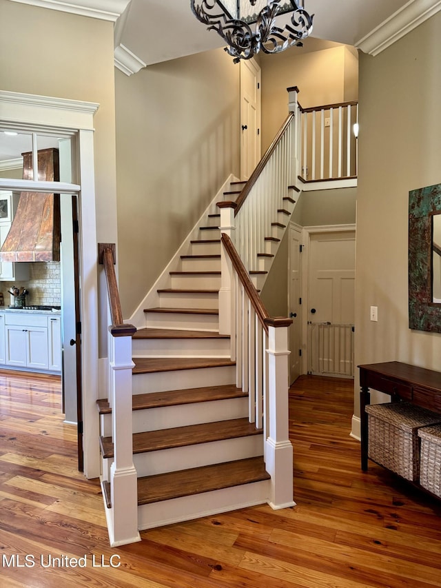 4 Mallard Xing, Raymond, MS 39154 - staircase with wood finished floors, ornamental molding, and a chandelier