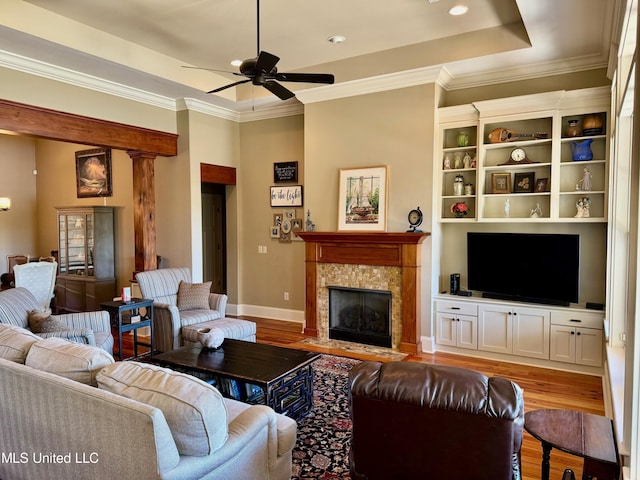 4 Mallard Xing, Raymond, MS 39154 - living area with a tray ceiling, baseboards, a ceiling fan, a fireplace, and wood finished floors