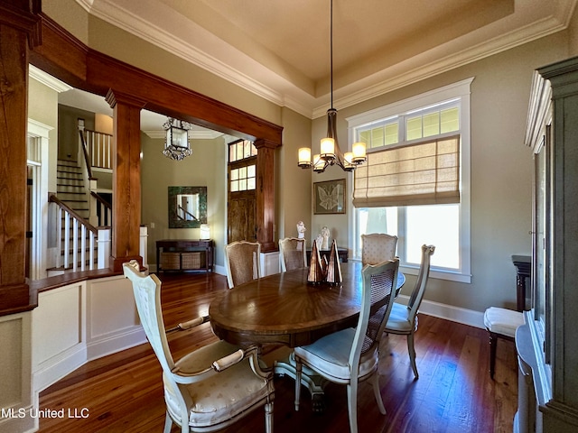 dining room featuring an inviting chandelier, ornamental molding, dark wood-type flooring, and a wealth of natural light