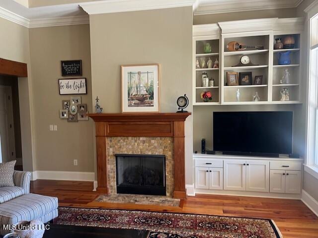 living room featuring wood-type flooring and ornamental molding