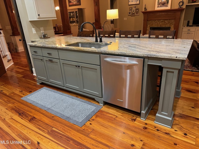 4 Mallard Xing, Raymond, MS 39154 - kitchen with stainless steel dishwasher, a sink, gray cabinets, wood finished floors, and a fireplace