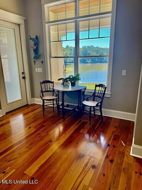 dining space with a water view and wood-type flooring