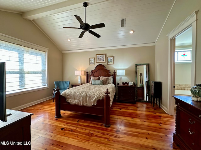 bedroom featuring multiple windows, hardwood / wood-style flooring, lofted ceiling with beams, and ceiling fan