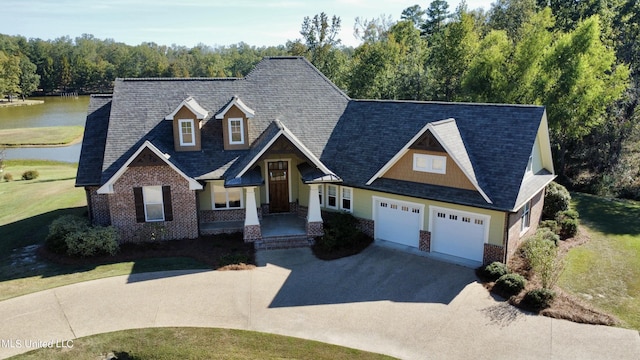 4 Mallard Xing, Raymond, MS 39154 - craftsman-style house featuring driveway, a water view, brick siding, covered porch, and a front yard