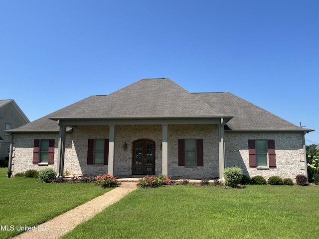 1306 Robert E Lee Dr, Greenwood, MS 38930 - view of front of house with a front yard, french doors, a shingled roof, and brick siding