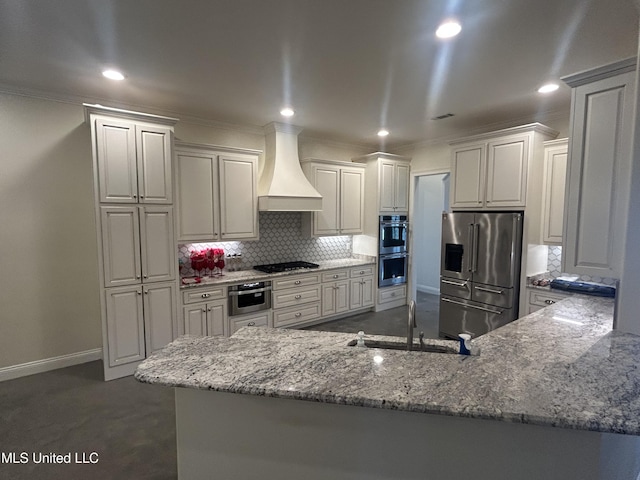 1306 Robert E Lee Dr, Greenwood, MS 38930 - kitchen featuring stainless steel appliances, premium range hood, backsplash, light stone counters, and ornamental molding