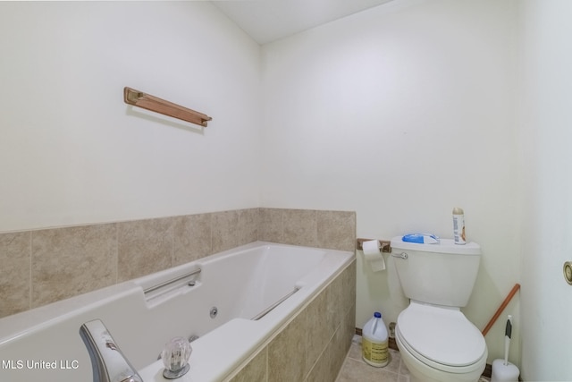 bathroom featuring toilet, tile patterned flooring, and a relaxing tiled tub