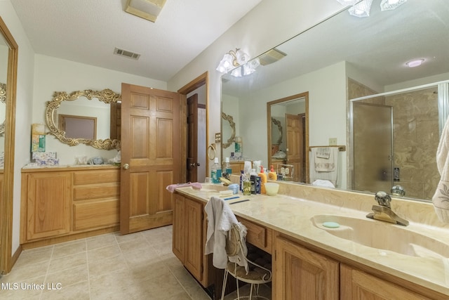 bathroom with vanity and a shower with door