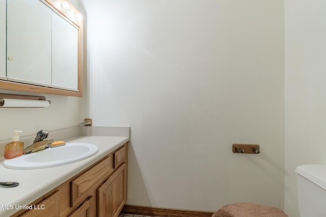 bathroom featuring toilet and vanity