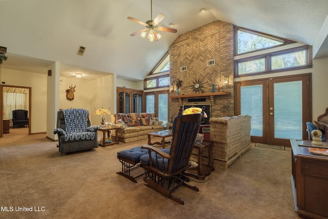 carpeted living room with a brick fireplace, ceiling fan, french doors, and high vaulted ceiling