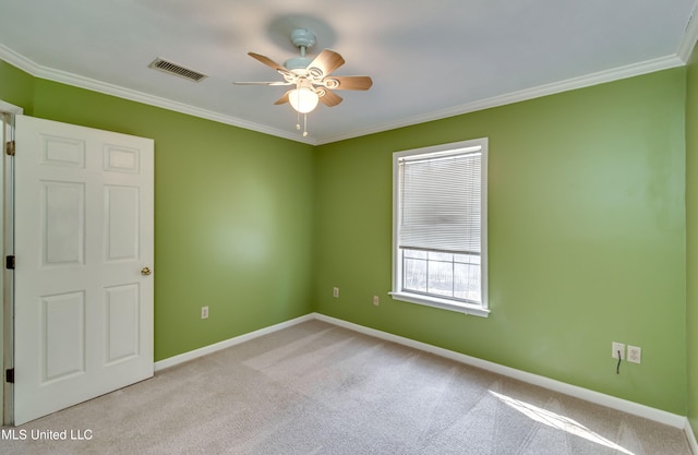 unfurnished room with ornamental molding, light colored carpet, and ceiling fan