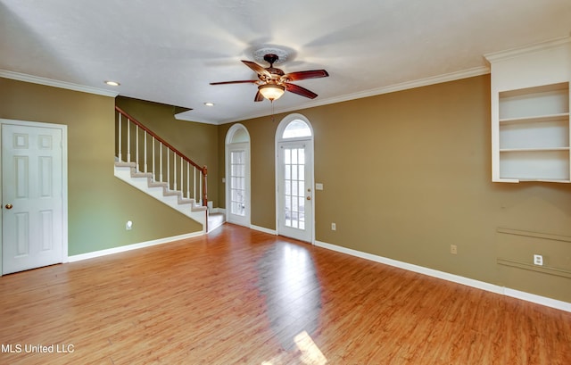 entrance foyer with crown molding, light wood-type flooring, and ceiling fan