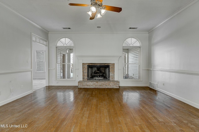 unfurnished living room with a fireplace, a wealth of natural light, and crown molding