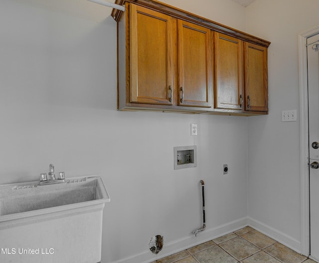 laundry area featuring sink, light tile patterned flooring, washer hookup, electric dryer hookup, and cabinets