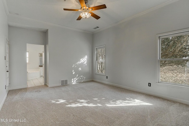 unfurnished room with ceiling fan, crown molding, and light colored carpet