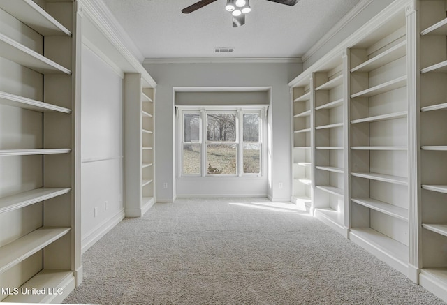 walk in closet with ceiling fan and light carpet