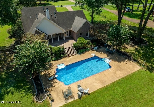 view of pool featuring a diving board, a patio area, and a yard