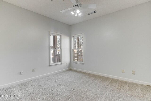 carpeted empty room with ceiling fan