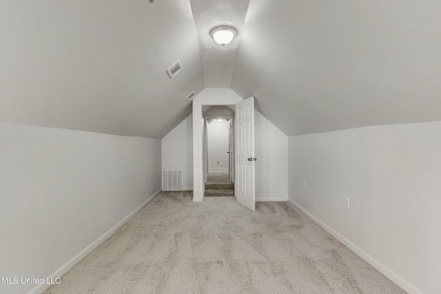 additional living space with lofted ceiling and light carpet