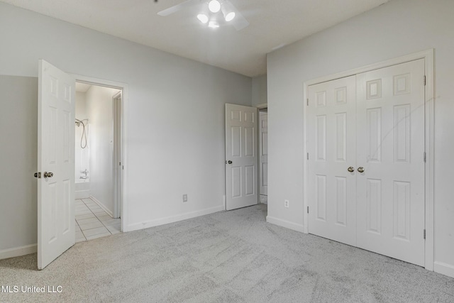 unfurnished bedroom with ceiling fan, a closet, and light colored carpet