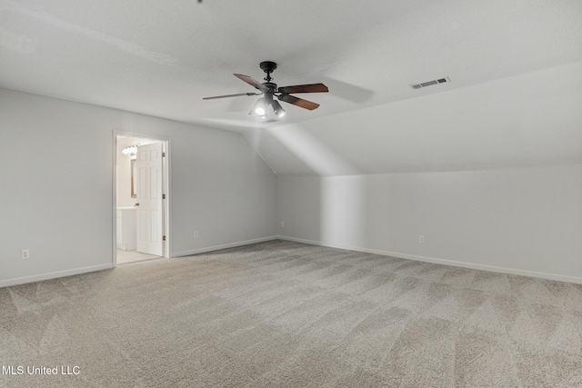 additional living space with ceiling fan, lofted ceiling, and light carpet