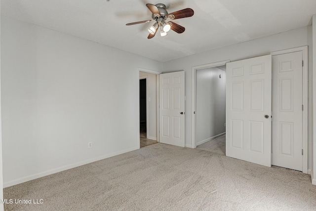 unfurnished bedroom featuring ceiling fan, a closet, and light carpet