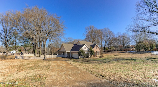 view of home's exterior featuring a garage and a yard