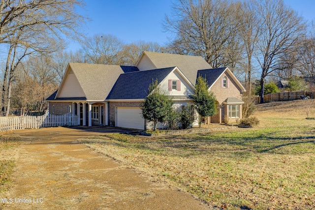 view of front facade featuring a front lawn and a garage