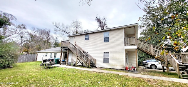 rear view of house featuring a yard