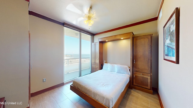 bedroom featuring a water view, ceiling fan, and crown molding