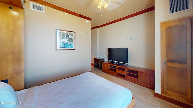 bedroom featuring ornamental molding, light hardwood / wood-style flooring, and ceiling fan