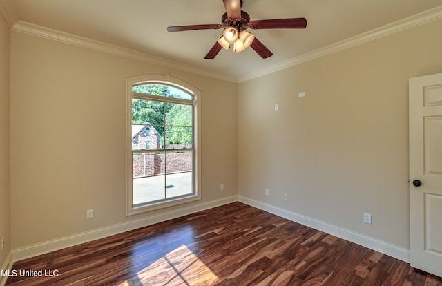 empty room featuring crown molding, dark hardwood / wood-style floors, and ceiling fan