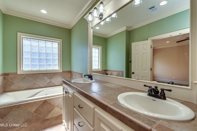 bathroom with vanity, a relaxing tiled tub, and ornamental molding