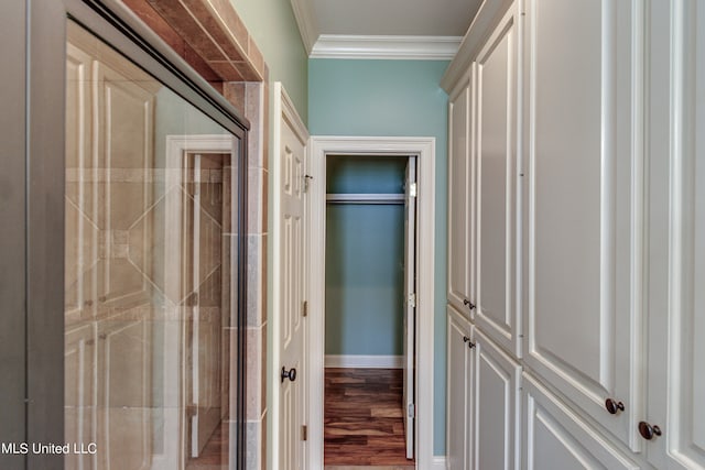 hall featuring ornamental molding and hardwood / wood-style flooring